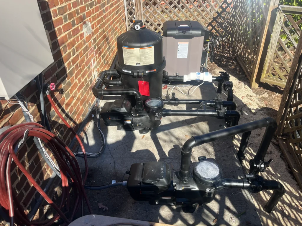 Pool pump and filtration system installed against a brick wall