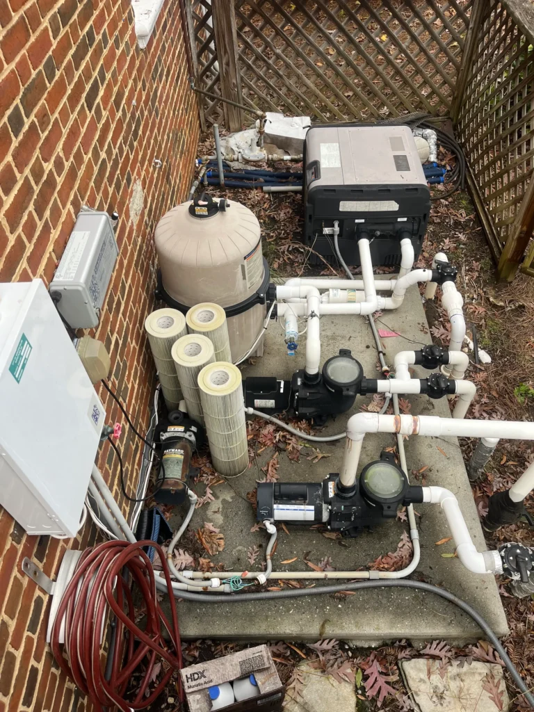 Old pool filtration system with exposed filter cartridges and piping