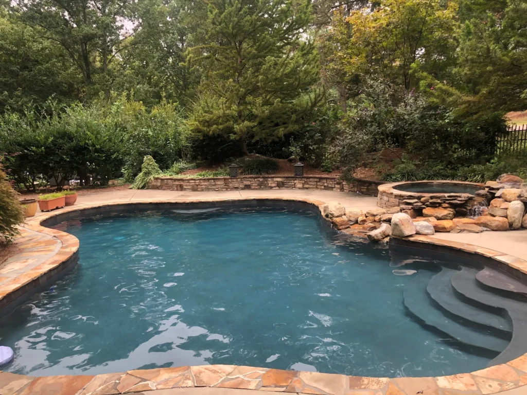 Aerial view of designer pool with irregular shape, spa area, and fountain