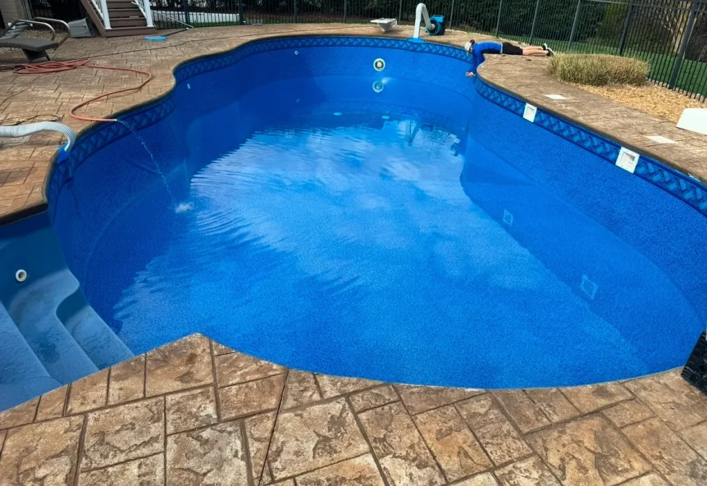 Refilled swimming pool with fresh blue liner partially filled with water