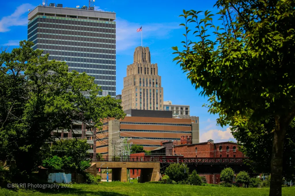 A city skyline rises in the background, with a lush green park in the foreground, inviting relaxation and leisure.