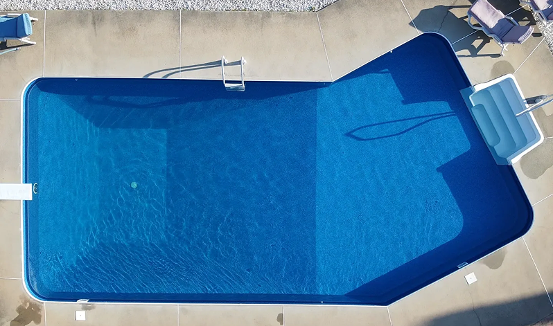 Same pool after renovation with new blue liner and filled with water