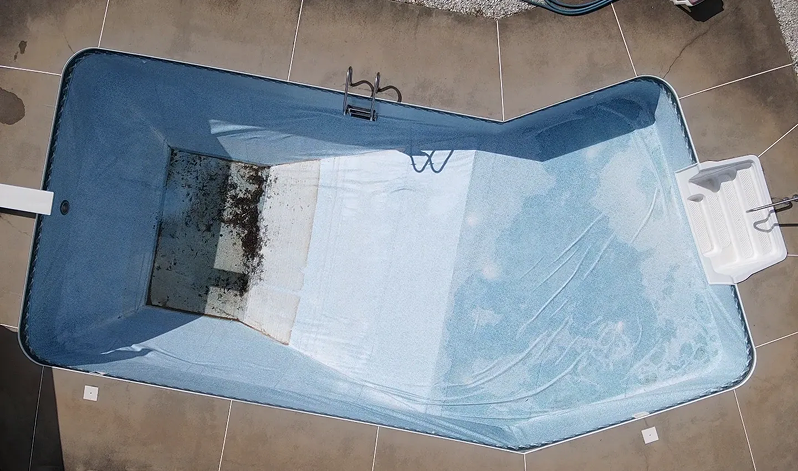 Empty pool photographed from above with visible dirt at the bottom